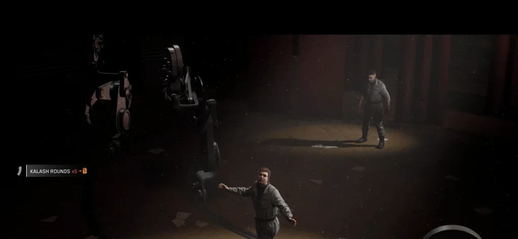 Man stands near robotic arm in dark room