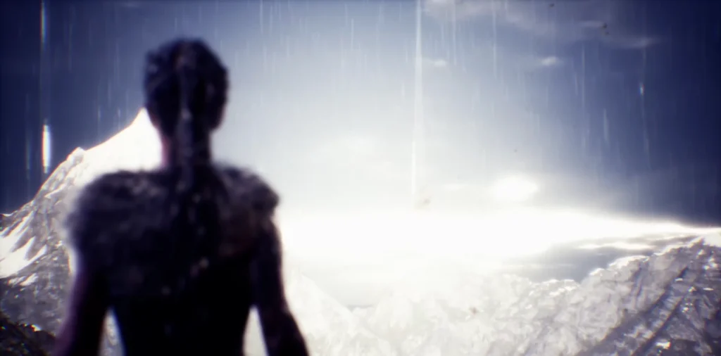 Silhouetted woman stands in rain over snowy mountains