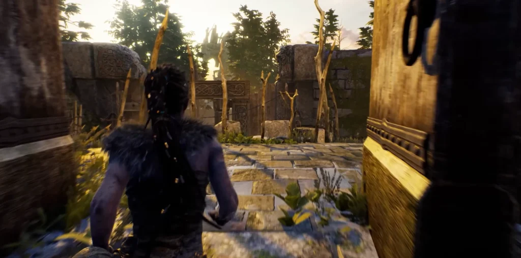 Senua walks through stone ruins in forest clearing