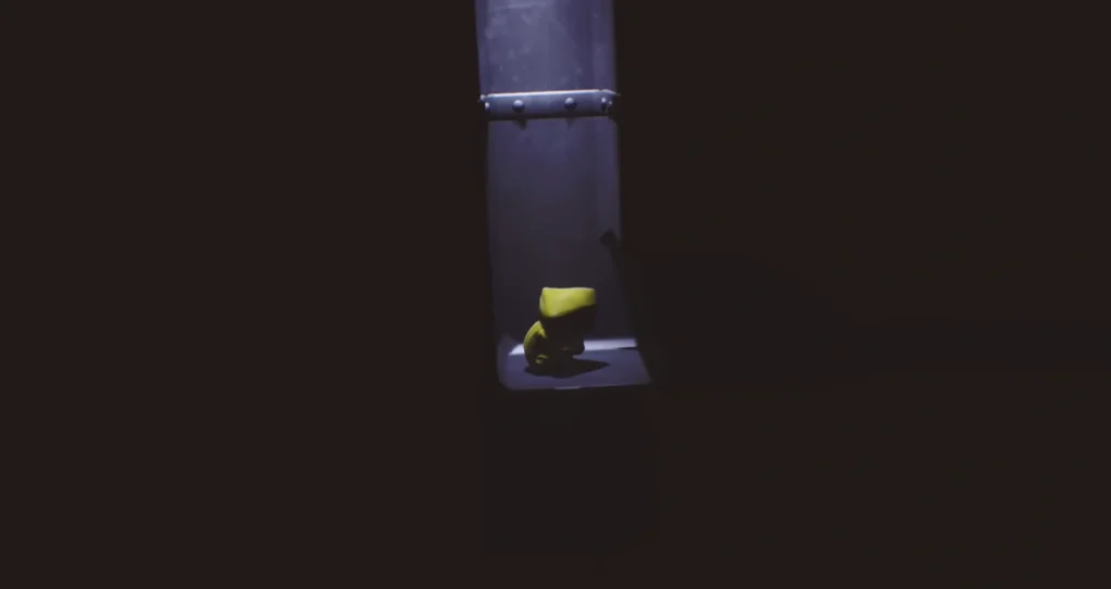 Six from Little Nightmares crouching on metal platform