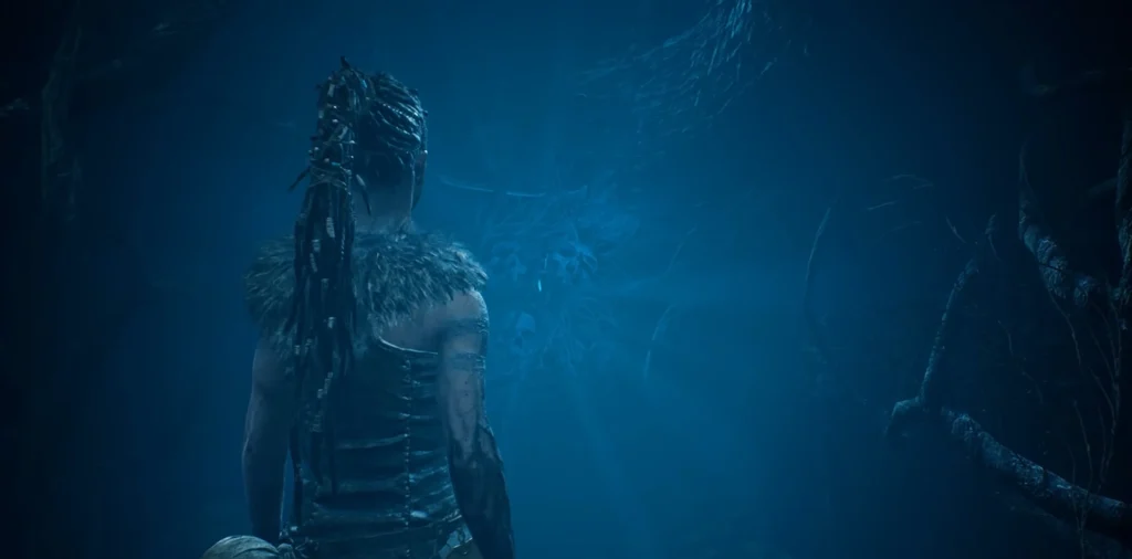 Senua stands in blue cave in Hellblade