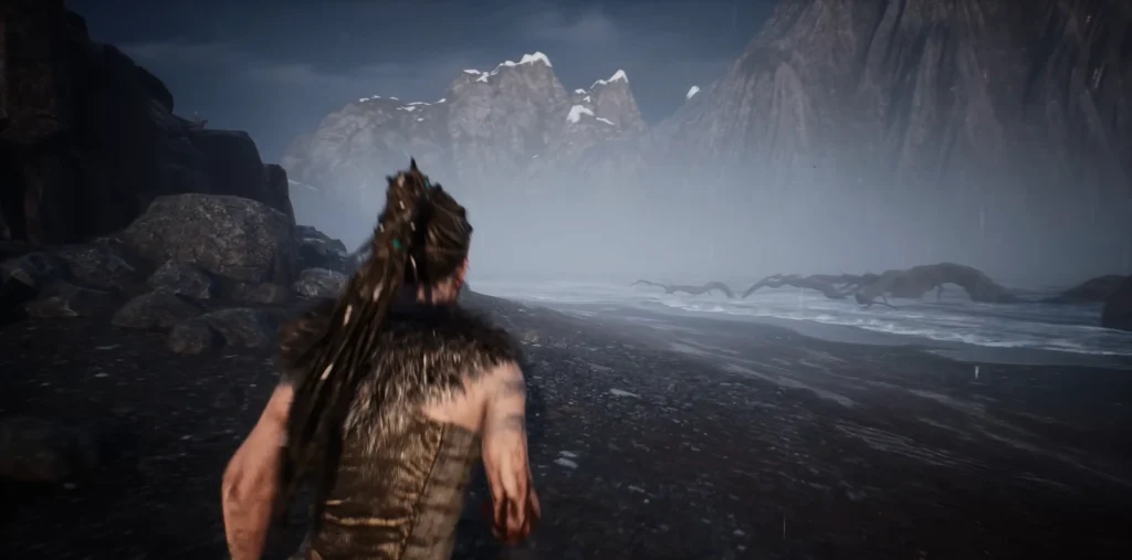 Senua from Hellblade running along rocky beach in rain