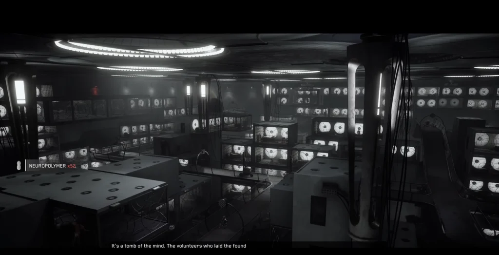 Glowing monitors fill dark industrial room with cables