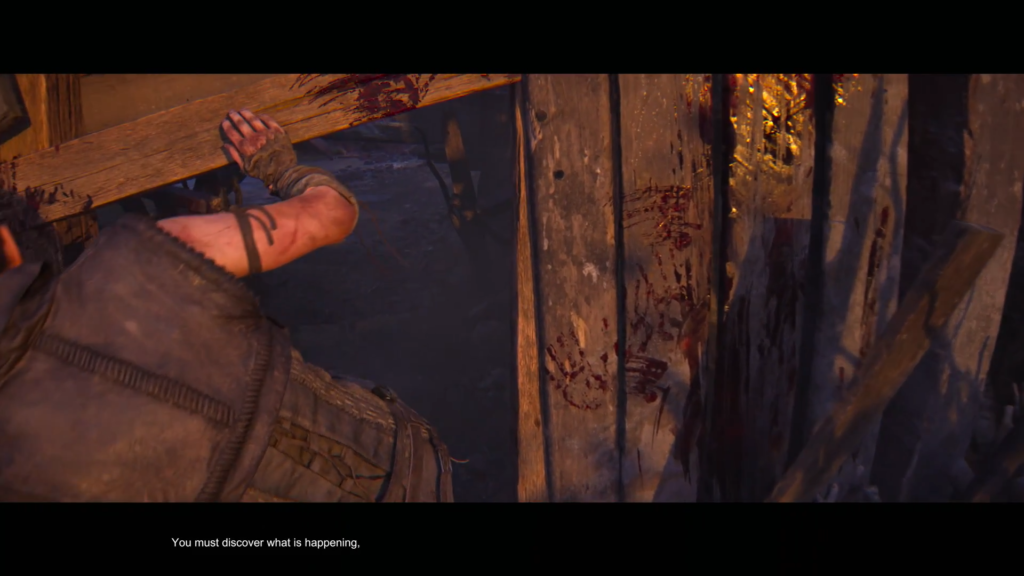 Person pushes wooden plank inside bloodstained shack