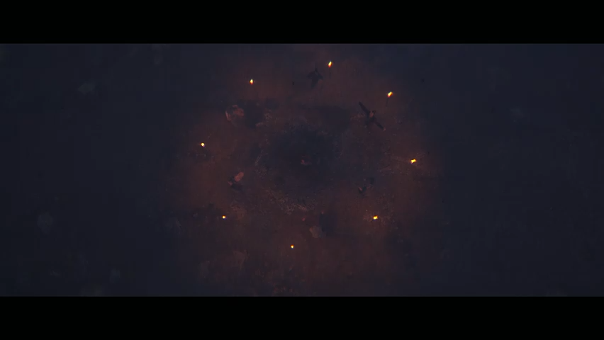 Glowing orange lights circling smoky crater in darkness