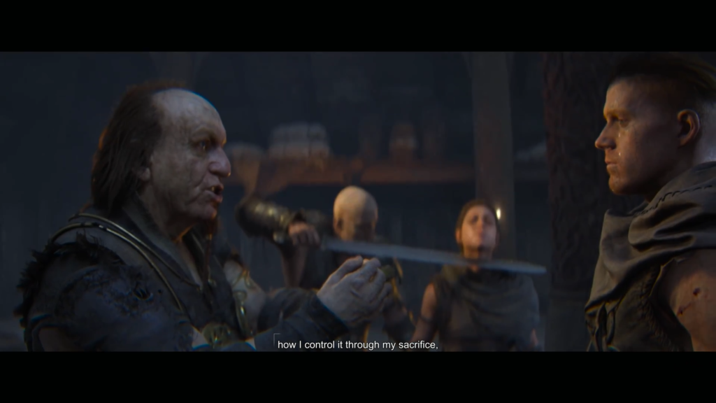 Man speaks to man in dim room