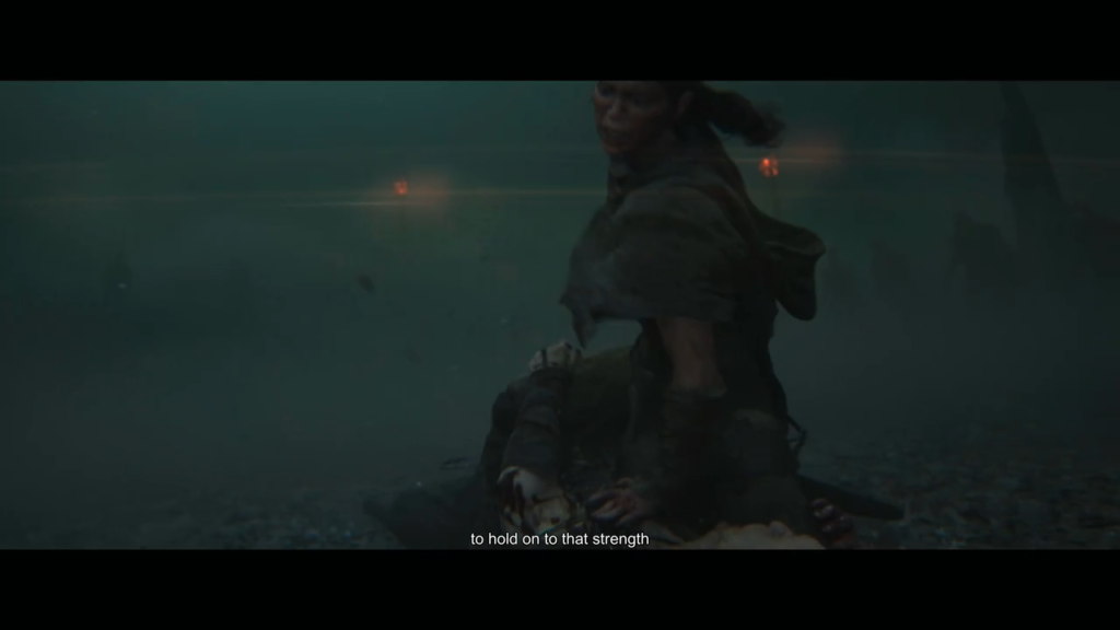 Woman kneeling beside injured person in foggy field