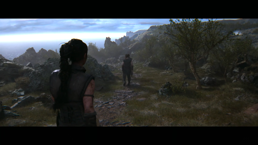 Two women walking along rocky coastal path