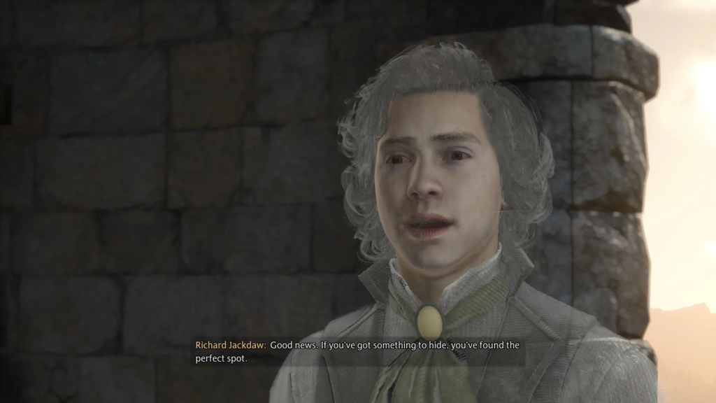 Richard Jackdaw speaks beside stone wall at sunset