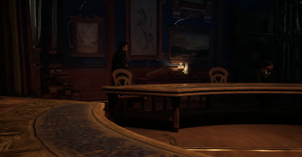 Person stands by desk in dim study room