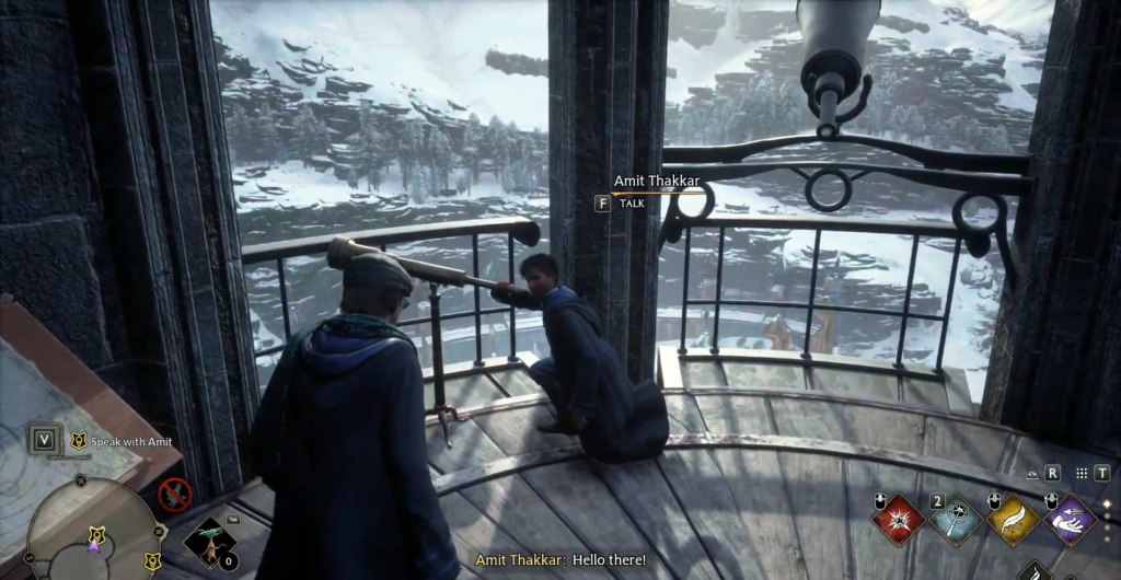 Amit Thakkar kneels by telescope on snowy balcony