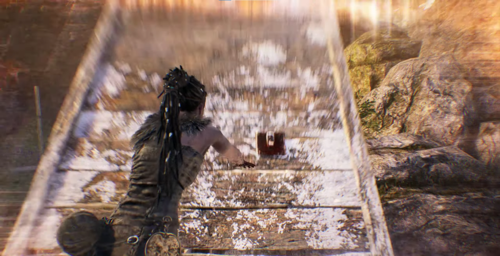 Senua pushing wooden cart on snowy path in Hellblade