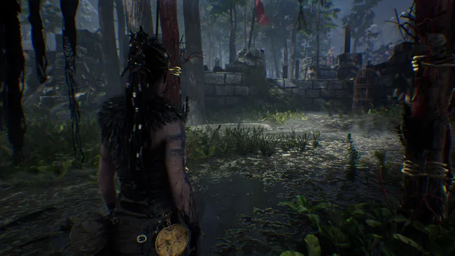 Senua walks through swampy forest ruins in Hellblade