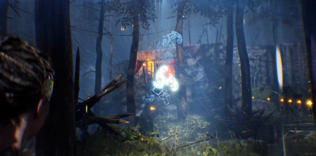 Glowing symbol hovers near cabin in dark forest