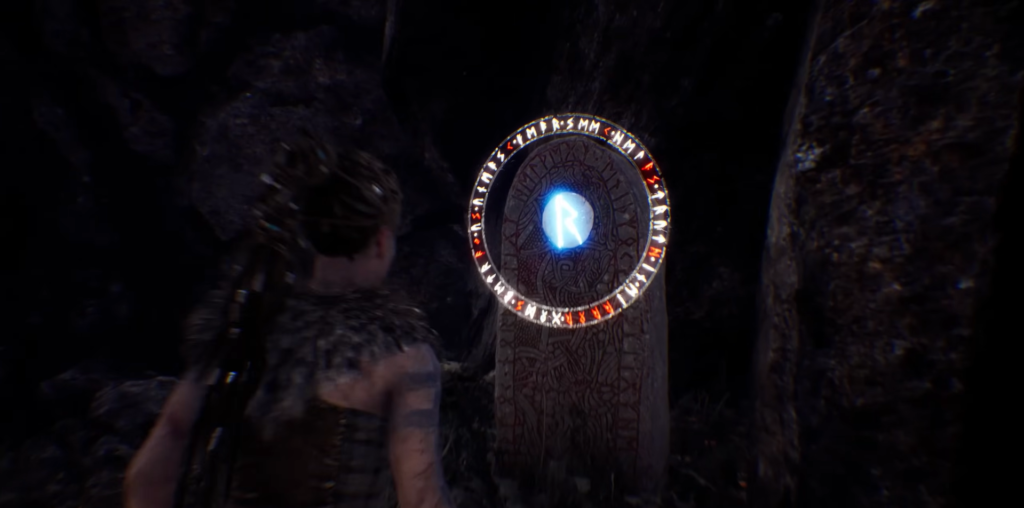 Senua examines glowing blue rune stone in cave