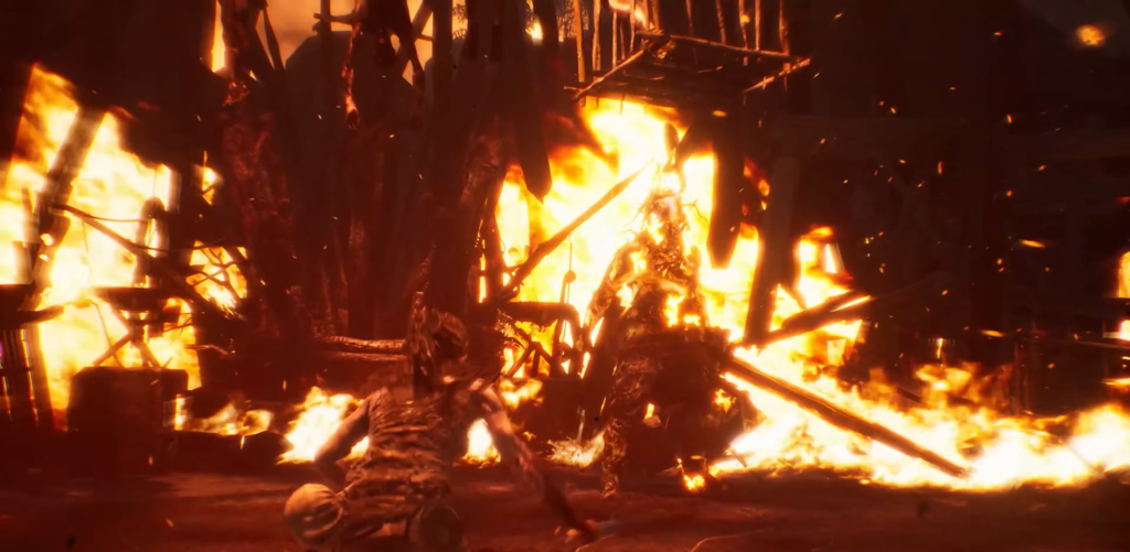 Person crawling from burning wreckage in flames