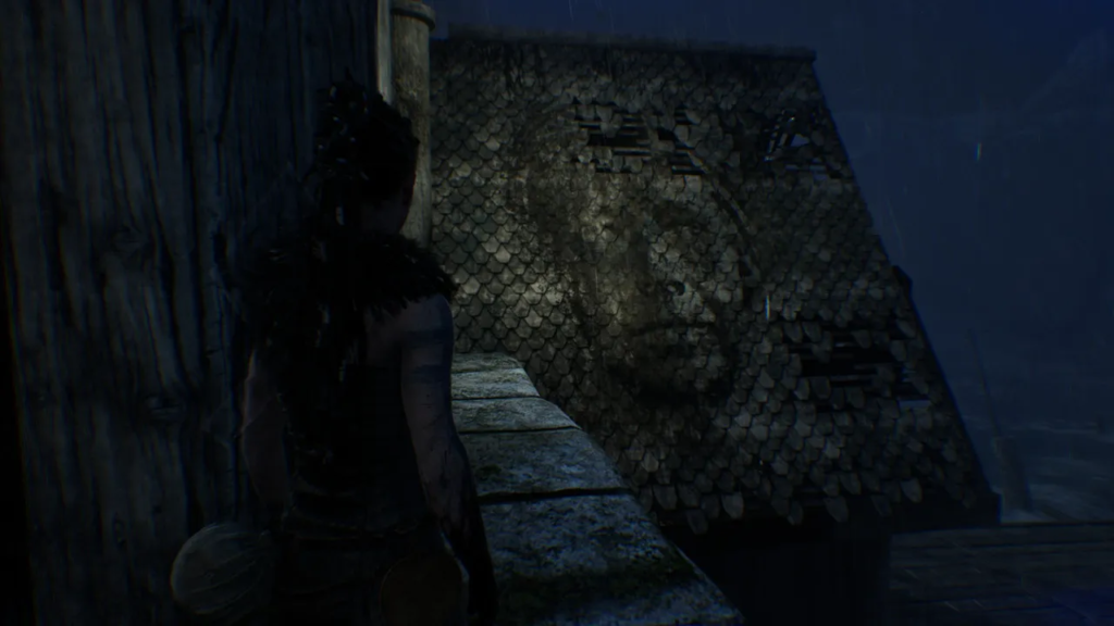 Senua watches face mural on rooftop in rain