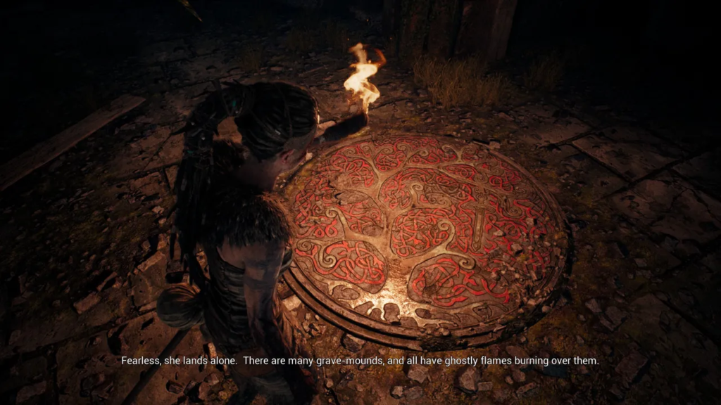 Senua holds torch over red rune stone circle