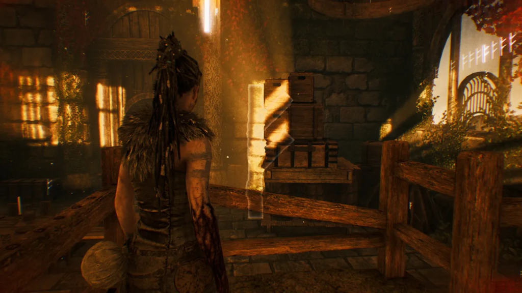 Senua from Hellblade stands in sunlit stone courtyard