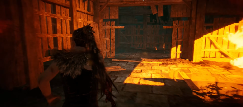 Warrior walking inside wooden barn with sunlight shadows