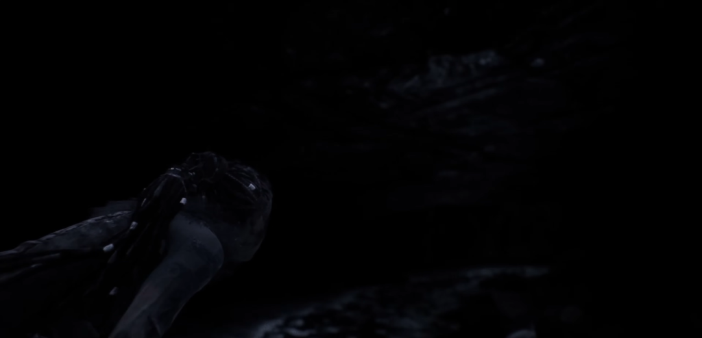 Женщина лежит в темноте на мокрой поверхности