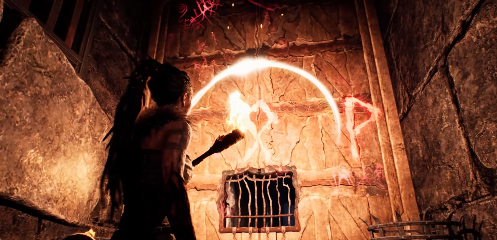 Senua holds torch near glowing runes on stone wall