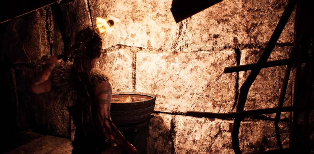 Woman holding torch beside stone wall indoors