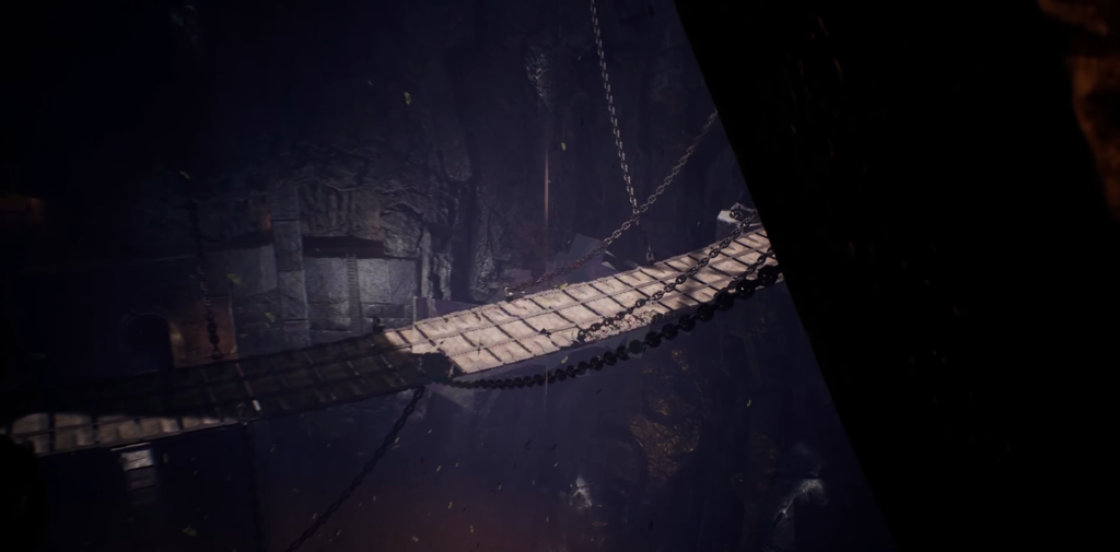 Wooden rope bridge hangs inside dark cave