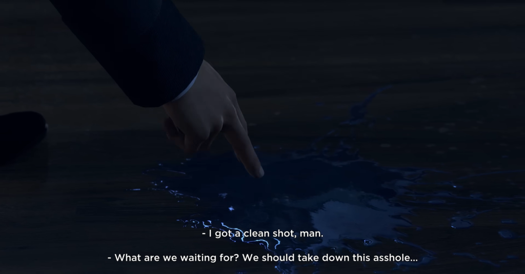 Hand points at blue puddle on floor