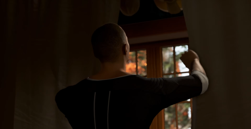 Man opening curtains by window indoors