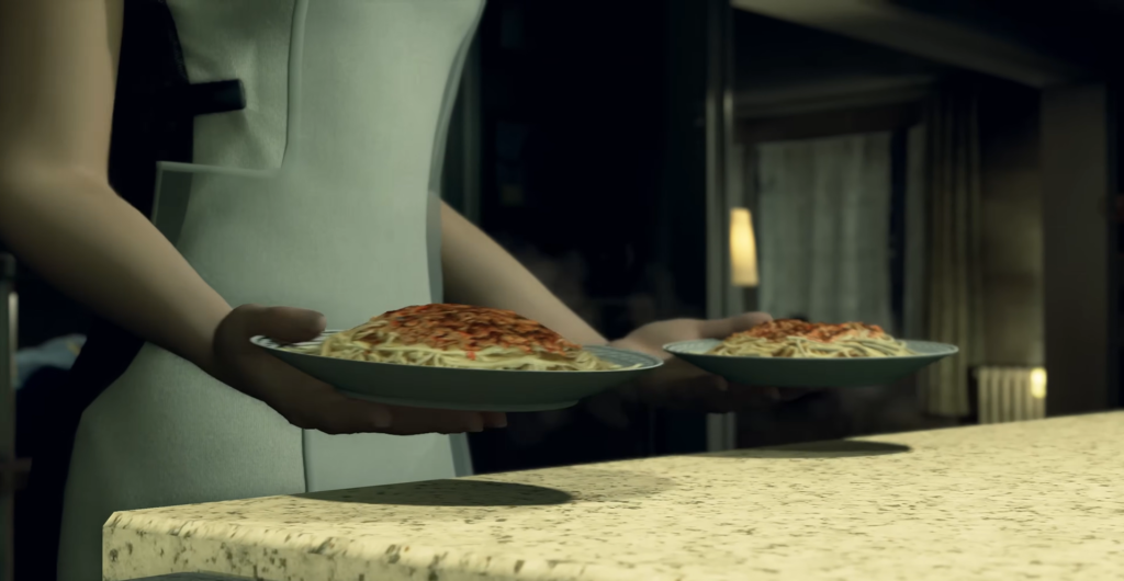 Person holding two plates of spaghetti at counter