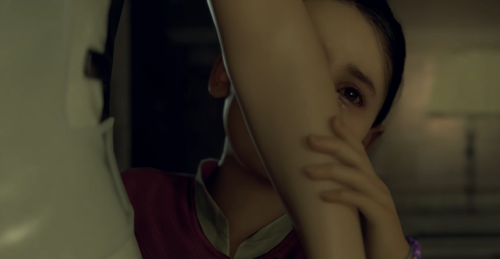 Girl holding arm near face indoors