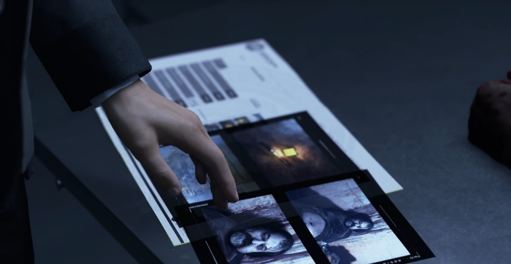 Hand sorting printed photographs on desk