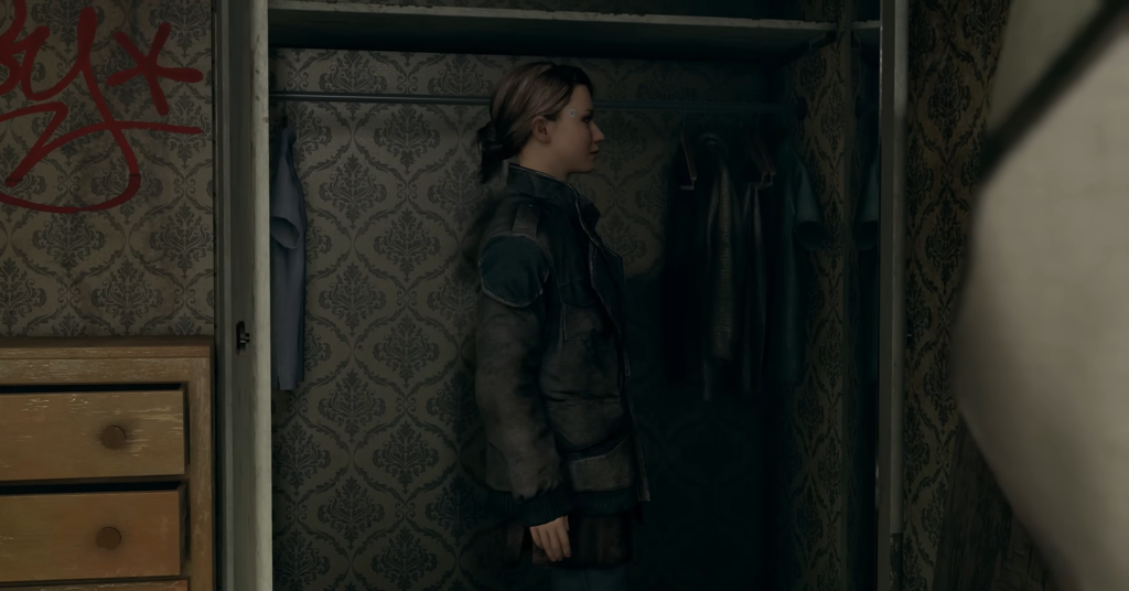 Woman standing in closet with hanging clothes