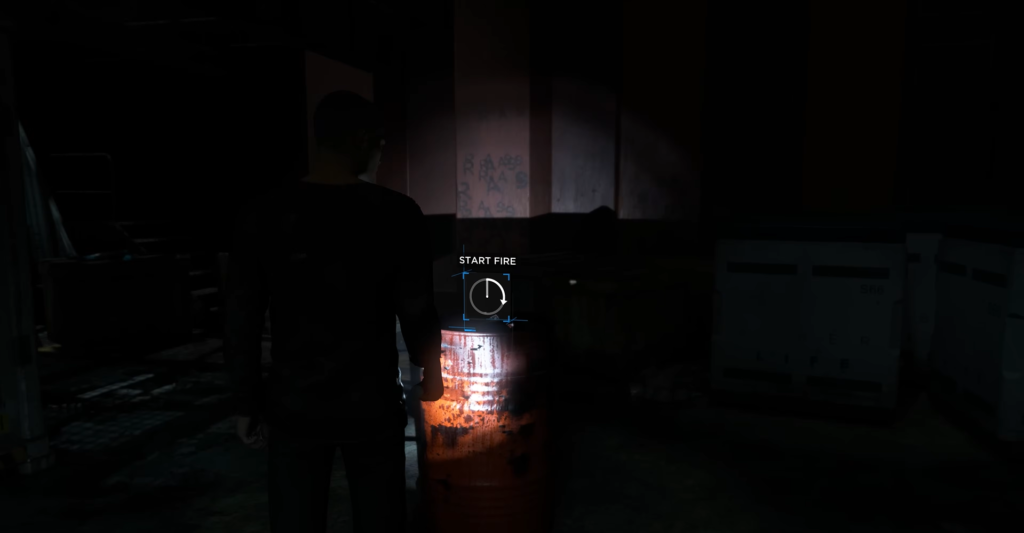 Man aims at orange barrel in dark room