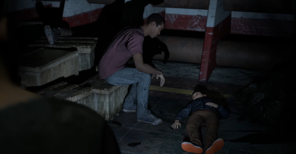 Boy sits on steps beside unconscious boy indoors