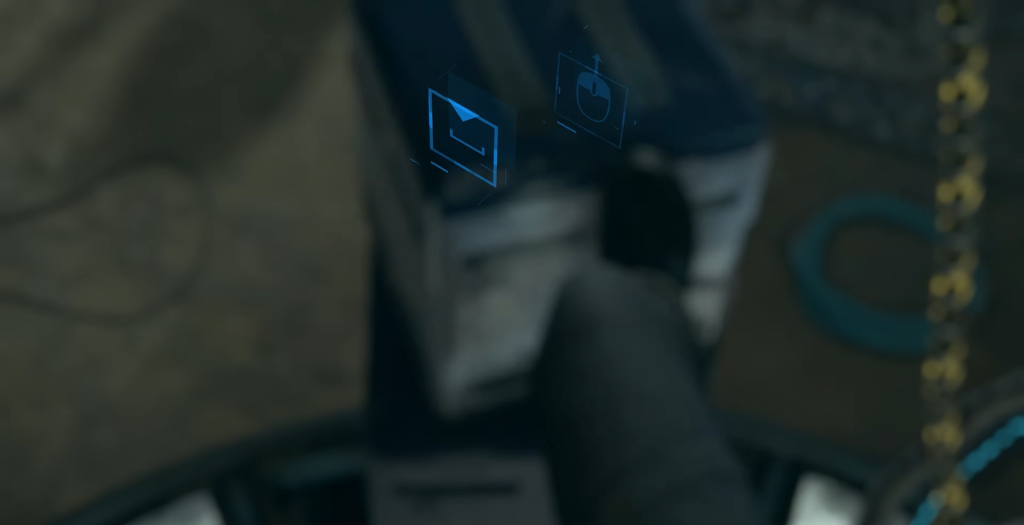 Person sits at desk with blue hologram icons