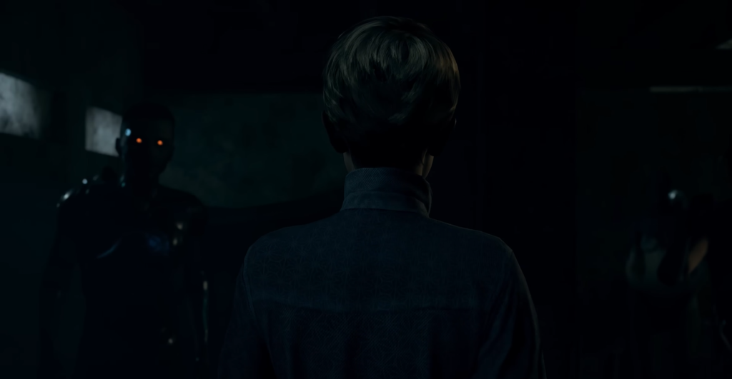 Person faces glowing-eyed robots in dark room