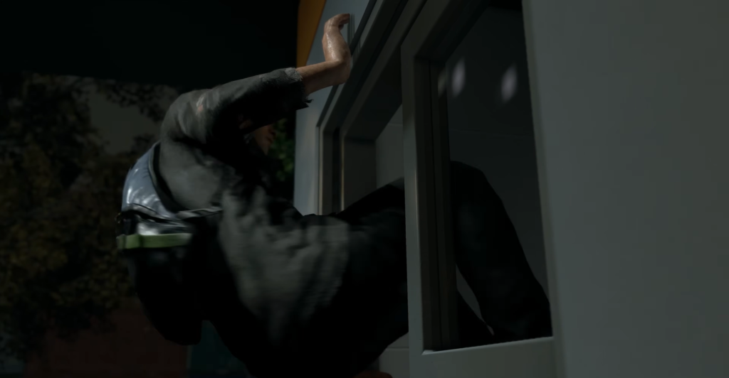 Person climbing through window at night outside house