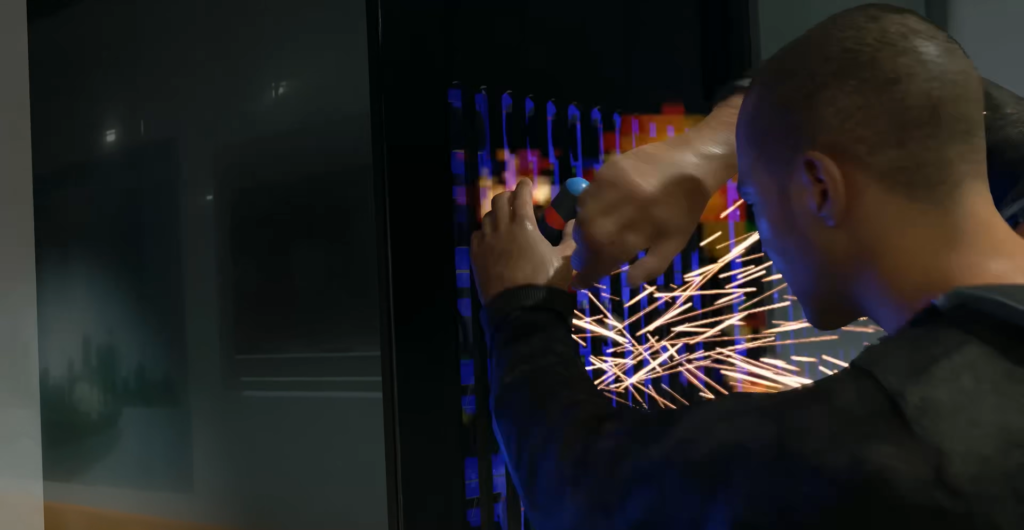 Man cutting metal panel with sparks indoors