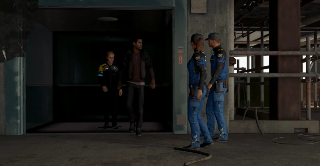 Two blue-uniformed workers talk outside industrial elevator