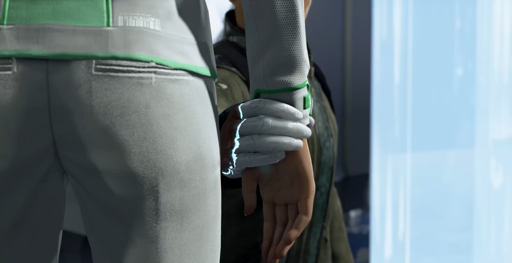 Gloved hand grabs person’s wrist indoors