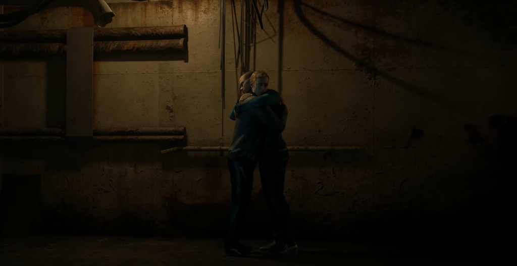 Two people hugging in dim industrial hallway