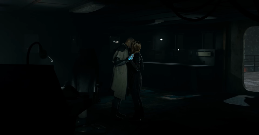 Two people embrace in dark room with blue light