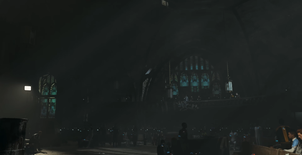 People sitting in dark church with stained glass