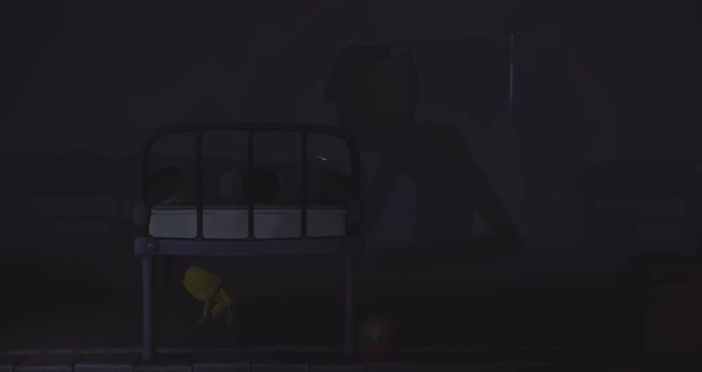 Yellow raincoat figure crouches under bed in dark room