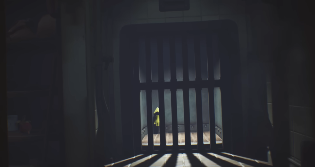 Six from Little Nightmares stands behind metal bars