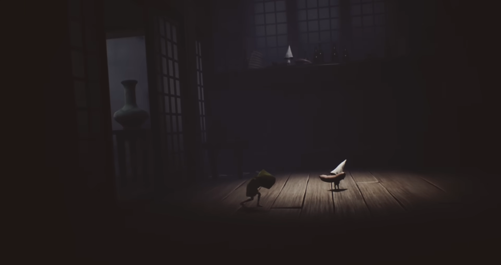 Six from Little Nightmares crouching on wooden floor indoors
