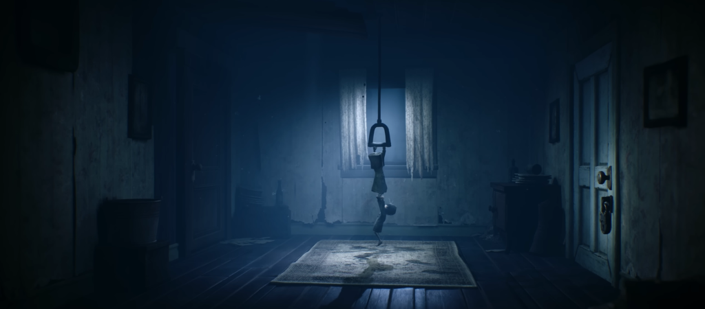 Child hanging from ceiling handle in dark room