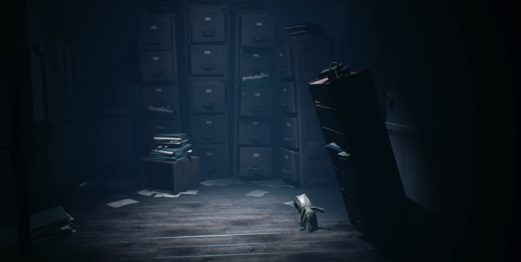 Small hooded figure walking in dark filing room